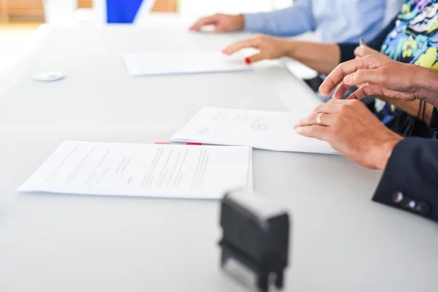 agreement, contract signing, table, hands, sign, contract, paper, paper work, meeting, business, closeup, agreement, contract, contract, contract, contract, contract. How do London talent agencies and regulators shape parenting creator deals?