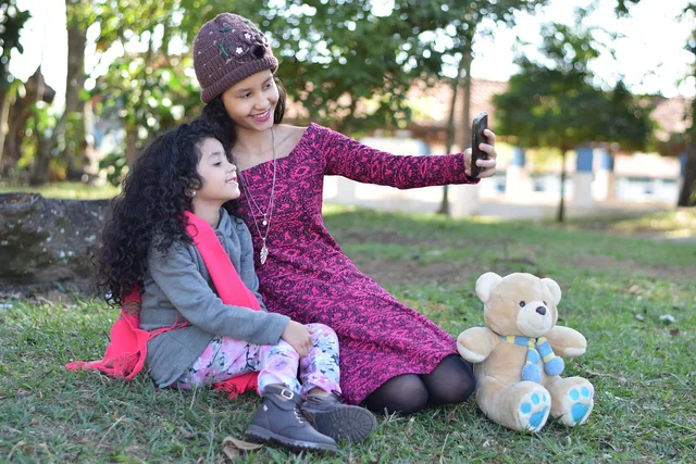 family, selfie, park, taking photo, woman, girl, child, kid, teddy bear, lawn, camera, smartphone, cell phone, outdoors. Working with TikTok family creators UK brands: campaign tips